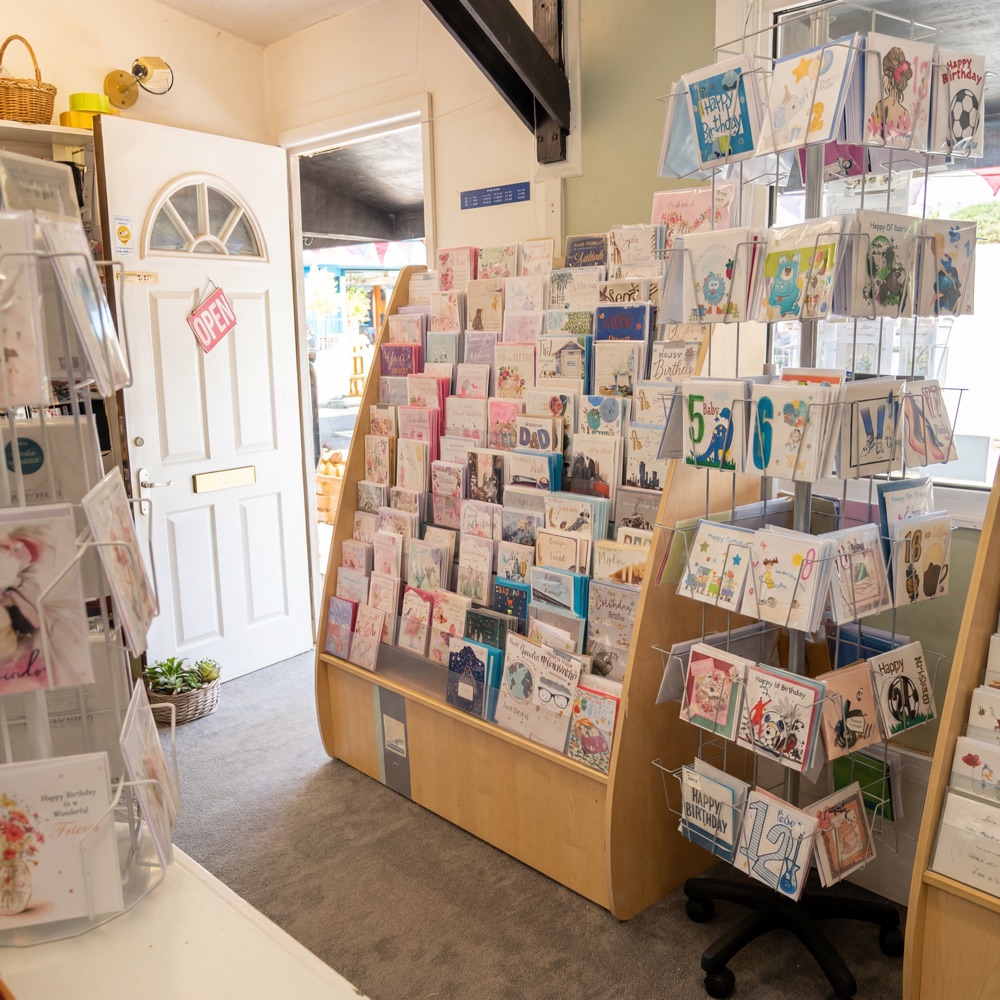 Inside The Craft Shop — greeting card displays by the open door